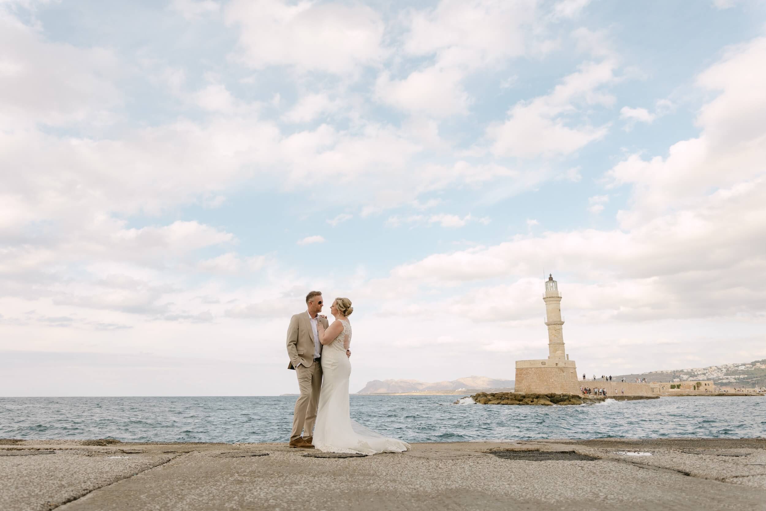 Bride and groom at Chania Harbour with the lighthouse, Crete