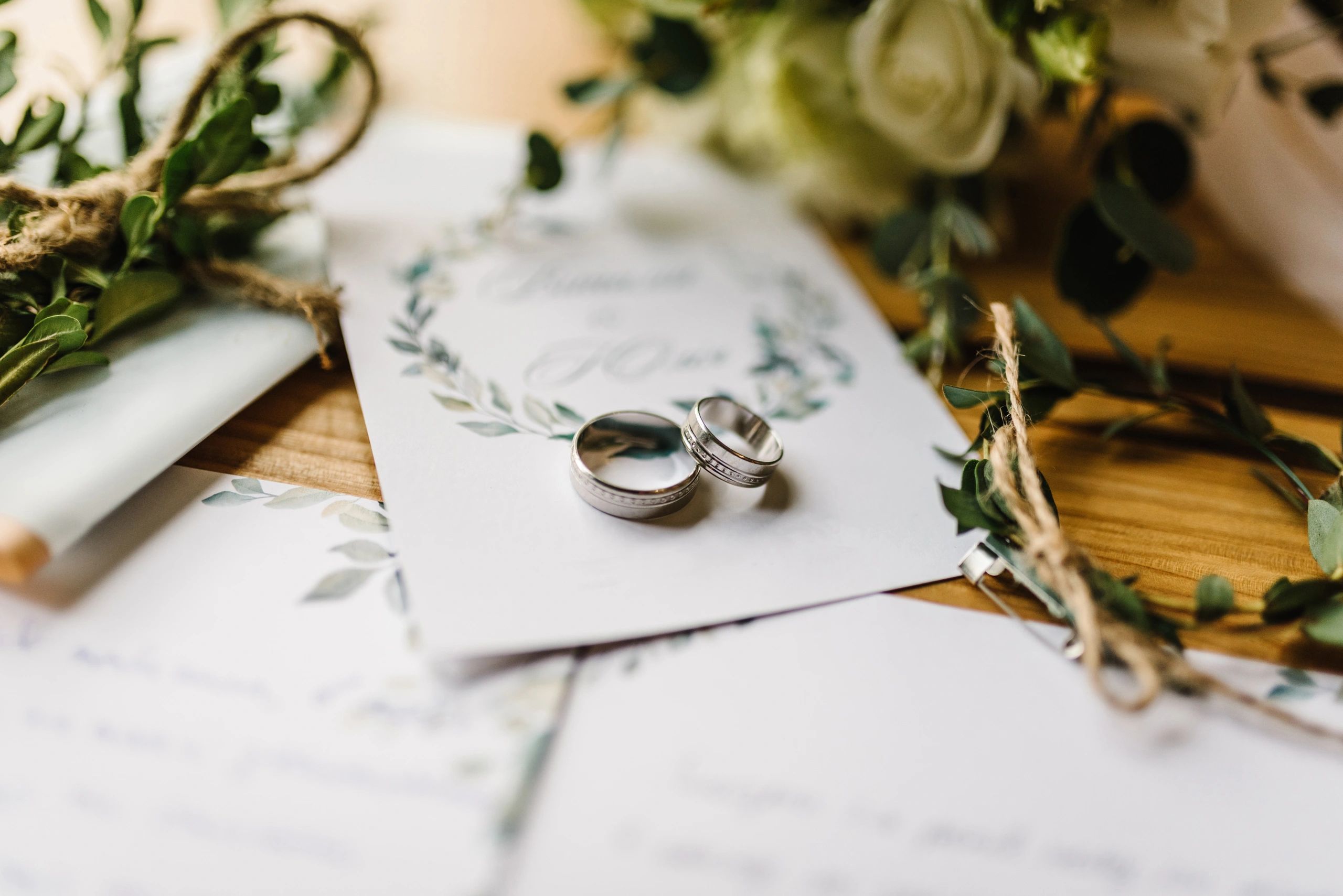 Wedding details flat lay with rings and flowers